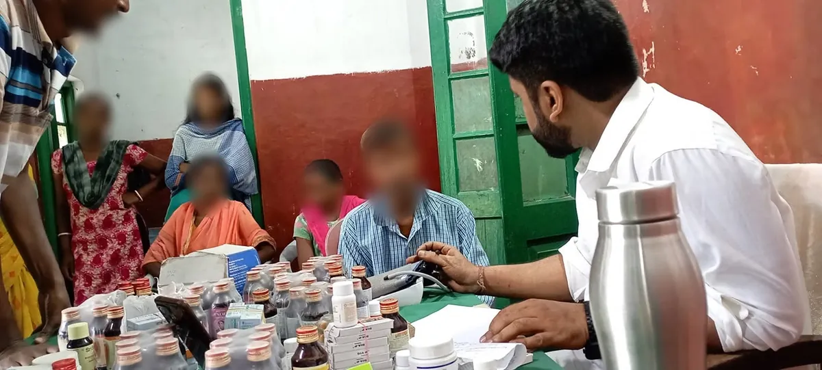 Checking a patient's blood pressure at the free health camp