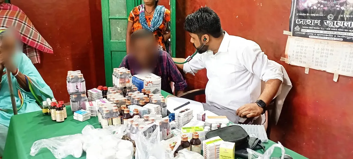 Dr. Manash examining a patient at a free health camp in a tea-garden community